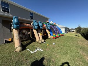 A infltable axe throwing game and 3 in 1 sports game blown up in back yard.